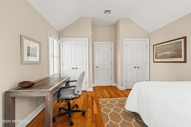 91 Cookman Ave, Ocean Grove, NJ 07756 - bedroom with two closets, baseboards, light wood-style floors, vaulted ceiling, and a desk