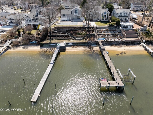 view of dock featuring a water view and a residential view