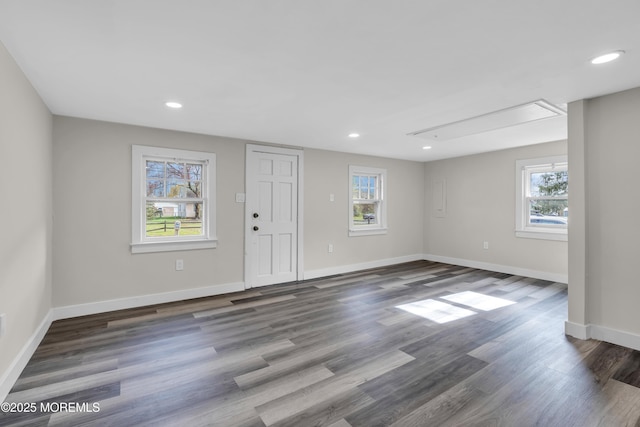 interior space featuring recessed lighting, baseboards, and wood finished floors