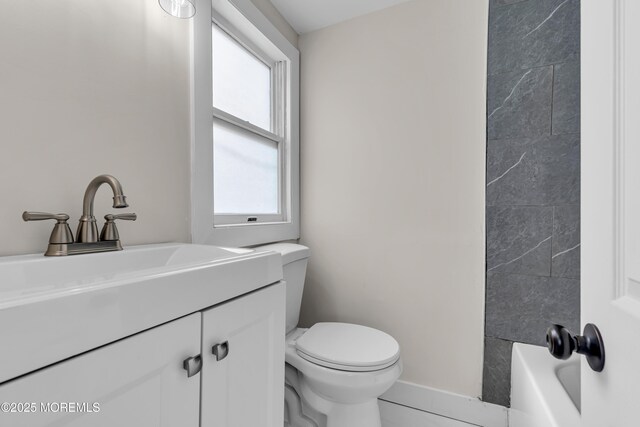 bathroom featuring toilet and vanity