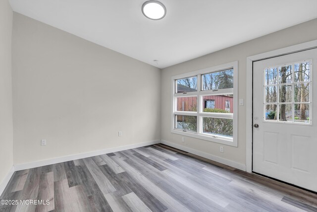 interior space featuring baseboards and wood finished floors