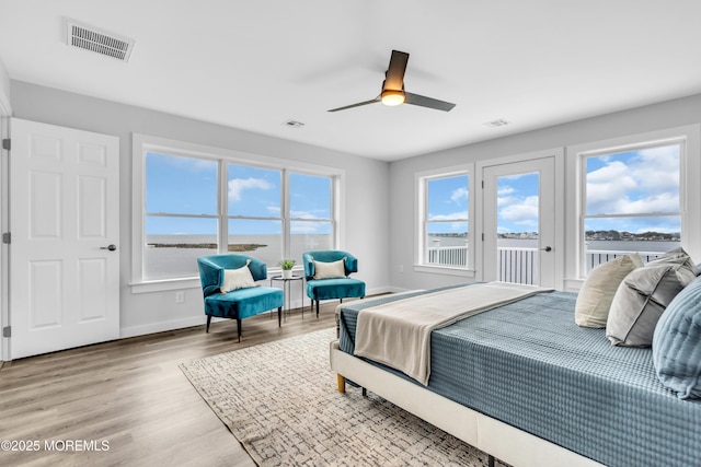 bedroom featuring access to outside, baseboards, light wood finished floors, and ceiling fan