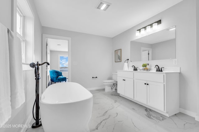 bathroom with marble look tiles, baseboards, double vanity, and toilet