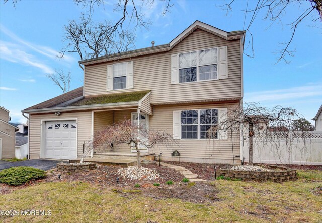 view of front of property featuring aphalt driveway and a garage