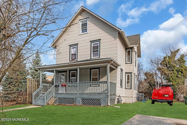 view of front of property with a front yard and covered porch