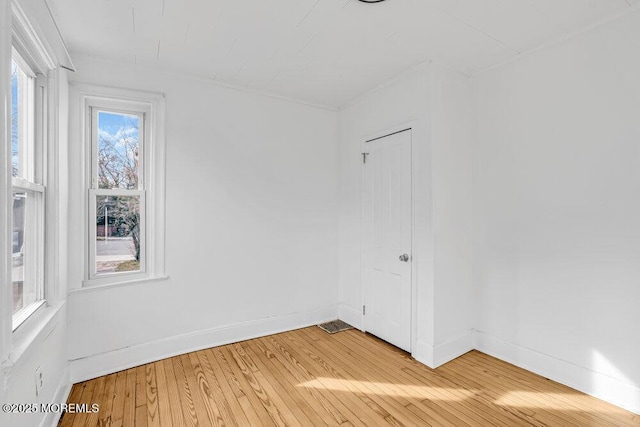 spare room with light wood-style flooring and baseboards