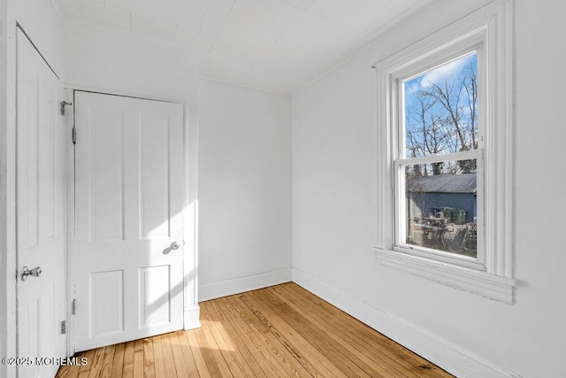 unfurnished bedroom featuring light wood-style flooring and baseboards