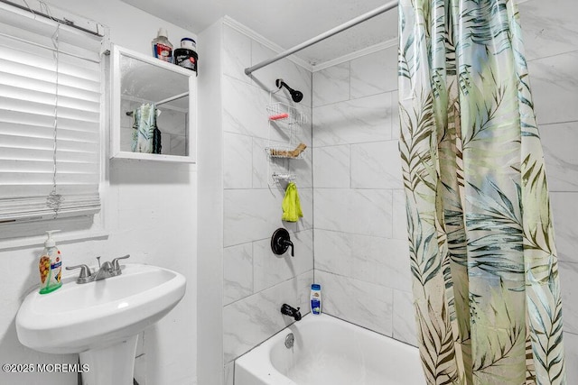bathroom featuring shower / tub combo, ornamental molding, and a sink
