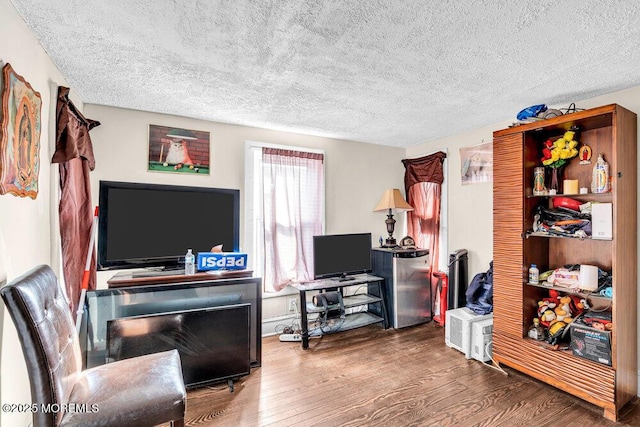 living area with a textured ceiling and wood finished floors