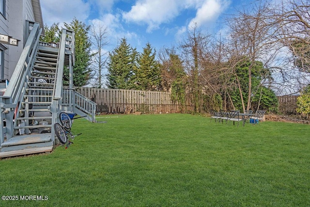 view of yard with stairway and fence