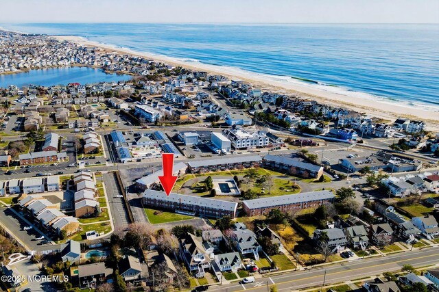 birds eye view of property with a beach view and a water view