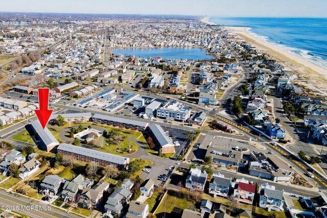 bird's eye view featuring a beach view and a water view