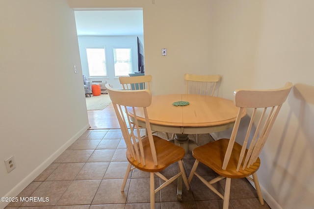 dining area featuring light tile patterned floors and baseboards