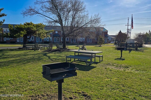 view of community featuring a yard and a residential view