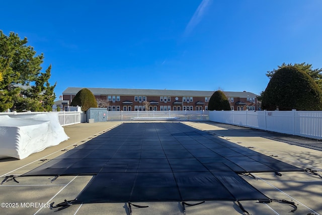 community pool featuring a patio area and fence