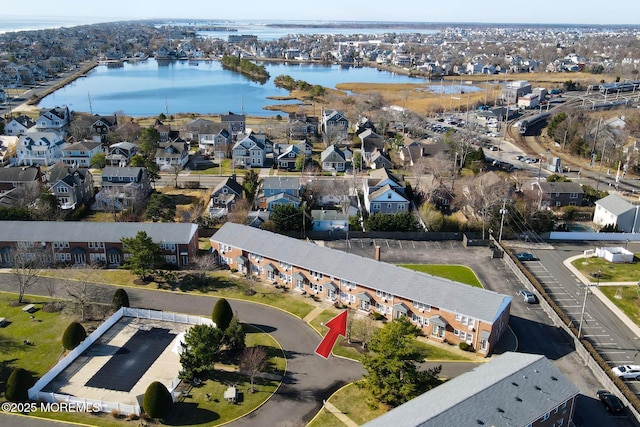 drone / aerial view featuring a residential view and a water view