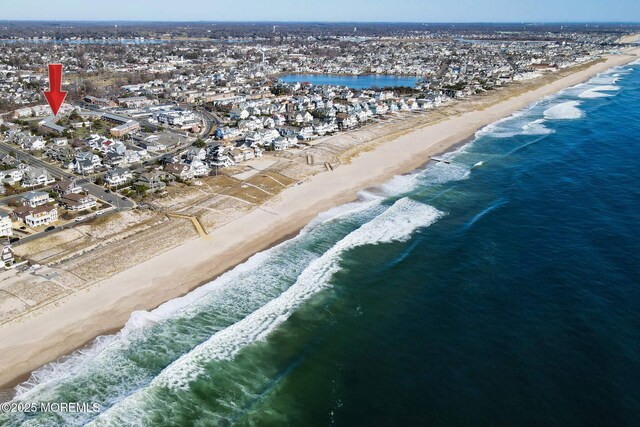 bird's eye view with a view of the beach and a water view