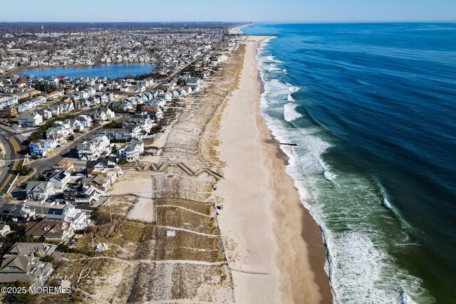 birds eye view of property with a beach view and a water view