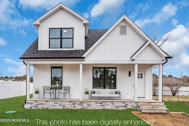 modern inspired farmhouse with a shingled roof and a porch