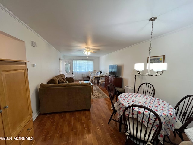 dining space featuring ceiling fan with notable chandelier, dark wood-type flooring, and ornamental molding