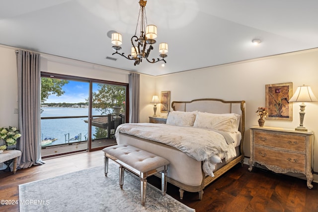 bedroom featuring an inviting chandelier, a water view, access to outside, visible vents, and wood finished floors