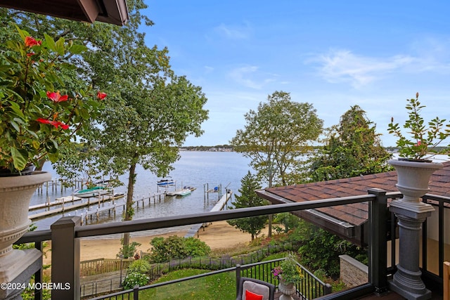 property view of water with fence and a boat dock