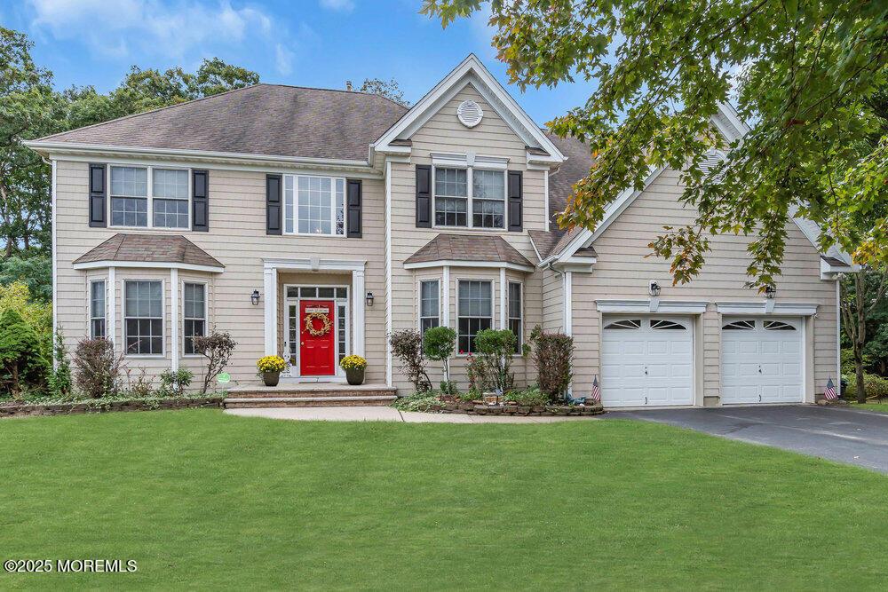 7 Taylors Run, Tinton Falls, NJ 07712 - view of front facade featuring a front lawn, a shingled roof, aphalt driveway, and an attached garage