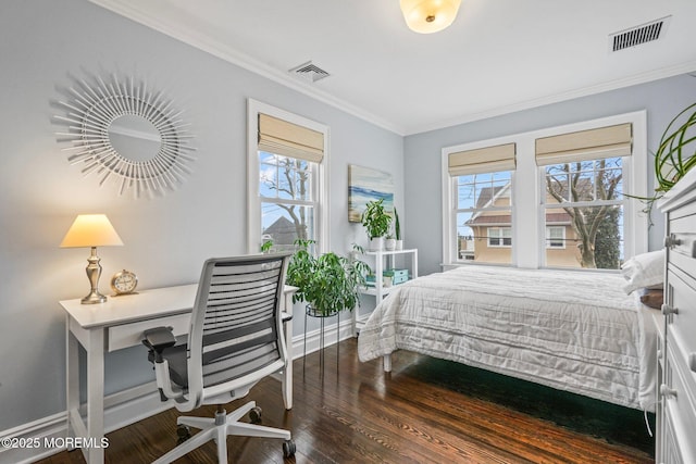 bedroom featuring baseboards, wood finished floors, visible vents, and ornamental molding