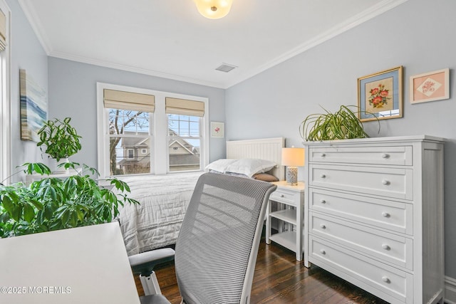 bedroom featuring dark wood finished floors, ornamental molding, and visible vents