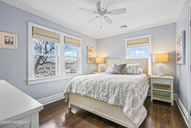 bedroom with baseboards, crown molding, and multiple windows