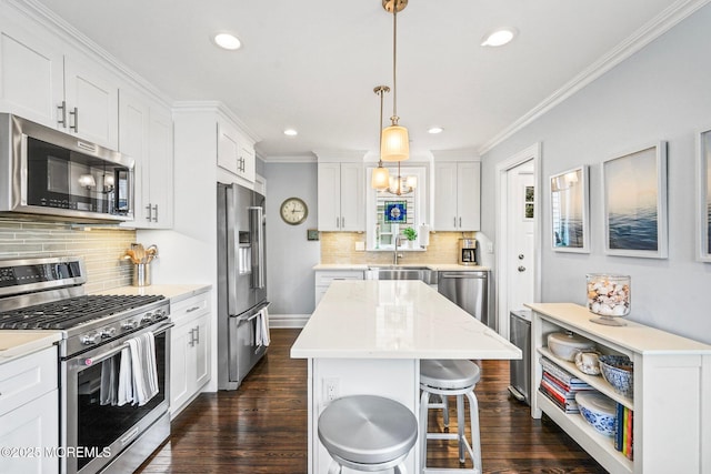 kitchen with white cabinetry, backsplash, appliances with stainless steel finishes, dark wood-type flooring, and ornamental molding