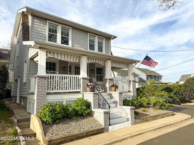 view of front of house with a porch and stairway