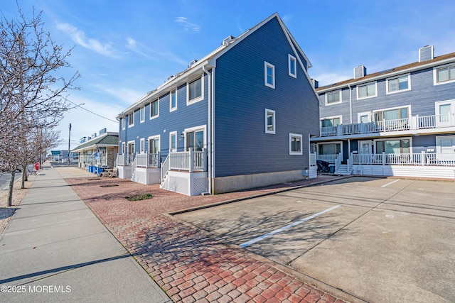 view of side of property with uncovered parking