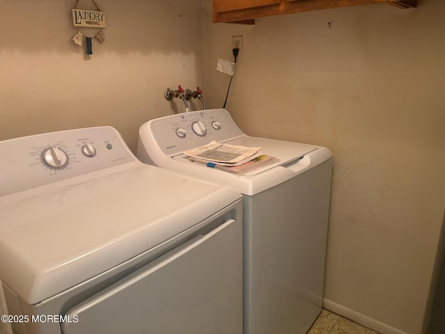 laundry area featuring independent washer and dryer, baseboards, and laundry area