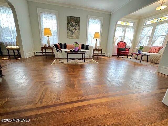 1022 Kennedy Blvd, Bayonne, NJ 07002 - living area featuring arched walkways, baseboard heating, crown molding, and baseboards