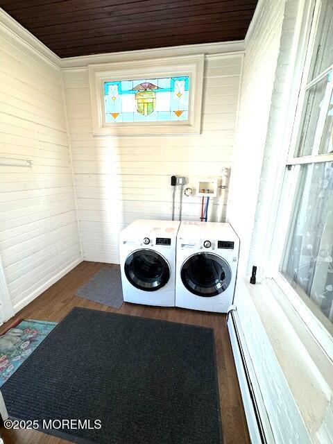 1022 Kennedy Blvd, Bayonne, NJ 07002 - clothes washing area with washing machine and clothes dryer, wood finished floors, wood walls, and a baseboard radiator