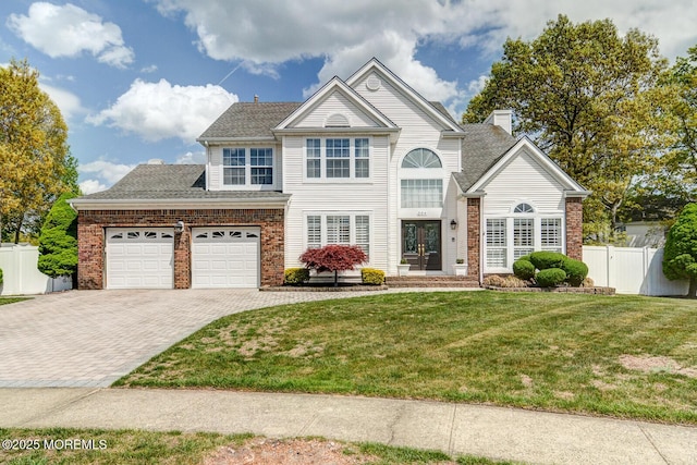 204 Lake Rd, Brick, NJ 08724 - traditional home featuring decorative driveway, french doors, brick siding, and an attached garage