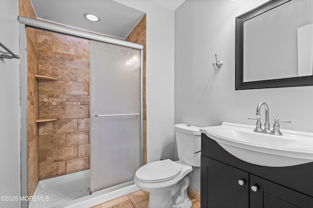 full bath featuring a shower stall, vanity, and toilet