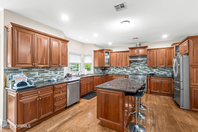 4 Friendship Ln, West Long Branch, NJ 07764 - kitchen with appliances with stainless steel finishes, under cabinet range hood, a sink, brown cabinetry, and recessed lighting