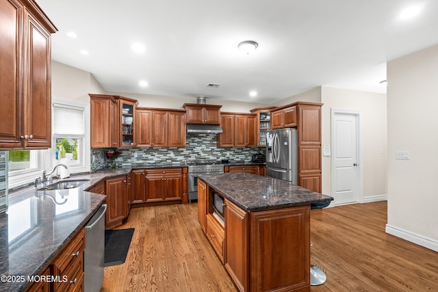 4 Friendship Ln, West Long Branch, NJ 07764 - kitchen featuring appliances with stainless steel finishes, a sink, under cabinet range hood, brown cabinets, and recessed lighting
