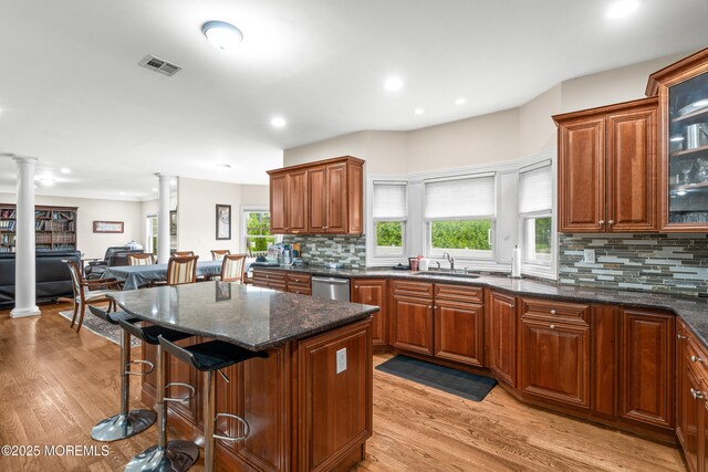 4 Friendship Ln, West Long Branch, NJ 07764 - kitchen with ornate columns, a sink, decorative backsplash, dishwasher, and a breakfast bar