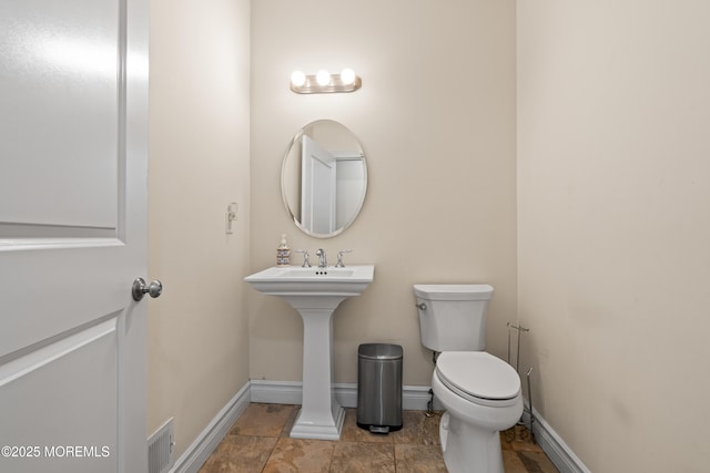 4 Friendship Ln, West Long Branch, NJ 07764 - bathroom featuring toilet, baseboards, and a sink