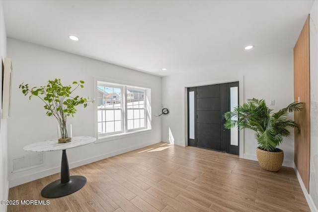 entryway with recessed lighting, baseboards, and wood finished floors