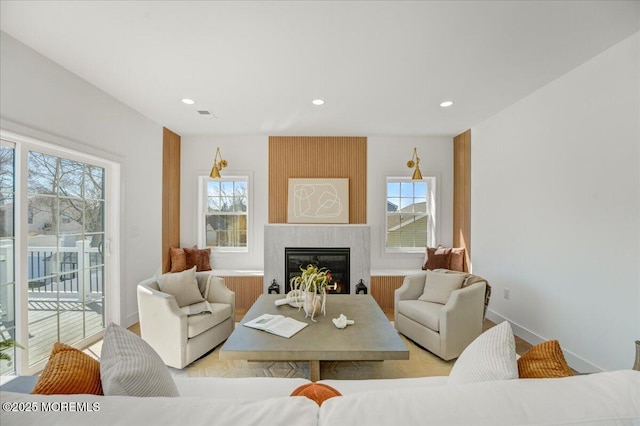 living room with baseboards, a fireplace, visible vents, and recessed lighting