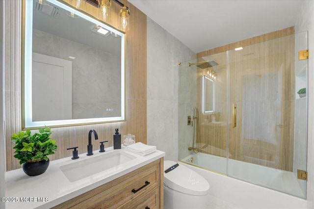 bathroom with enclosed tub / shower combo, toilet, and vanity