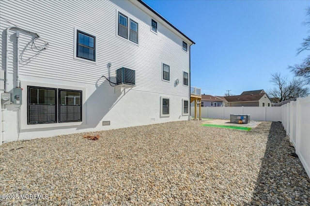back of house with stucco siding, a fenced backyard, and a patio