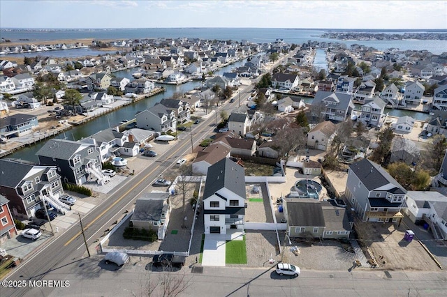 birds eye view of property with a residential view and a water view