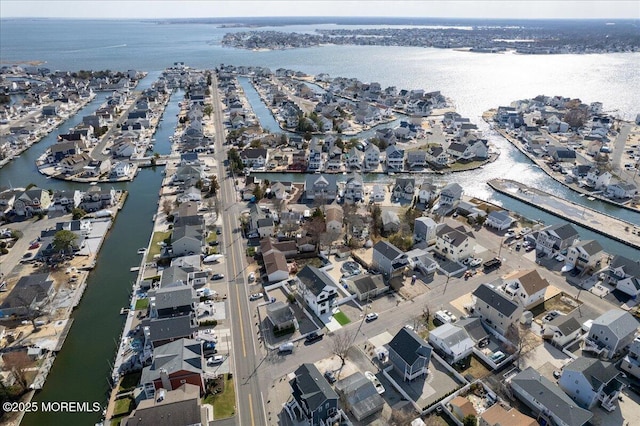 birds eye view of property featuring a water view and a residential view