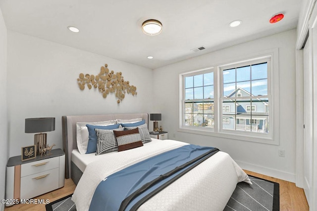 bedroom with recessed lighting, baseboards, light wood finished floors, and visible vents