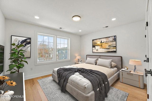 bedroom featuring baseboards, visible vents, light wood-style floors, and recessed lighting